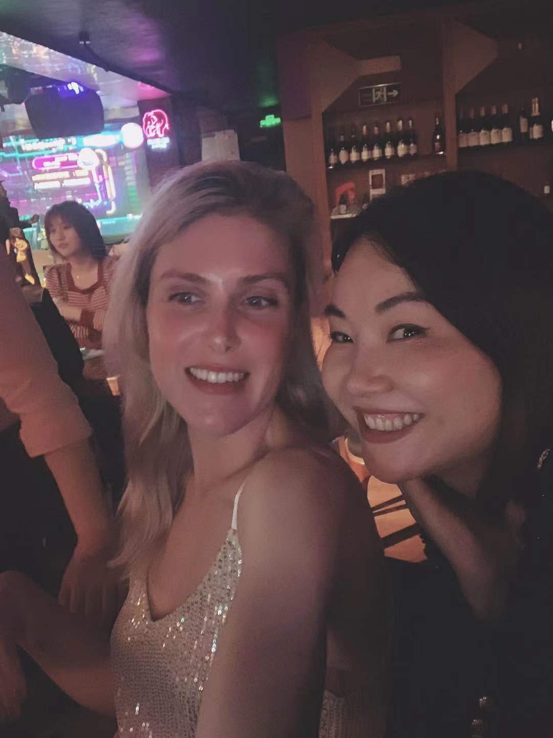 Two women smiling together on an evening out