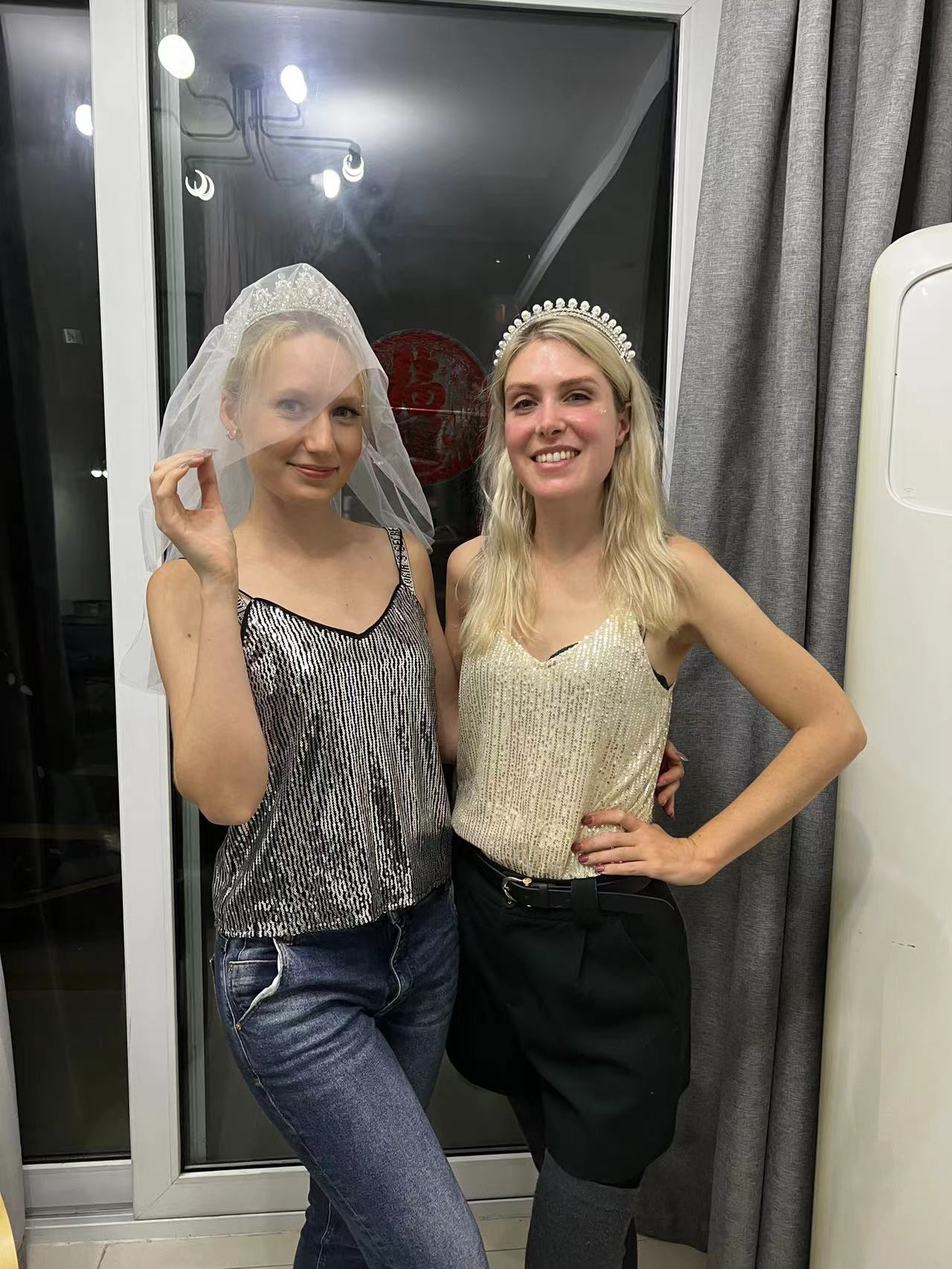 Rebecca and a friend posing together wearing tiaras