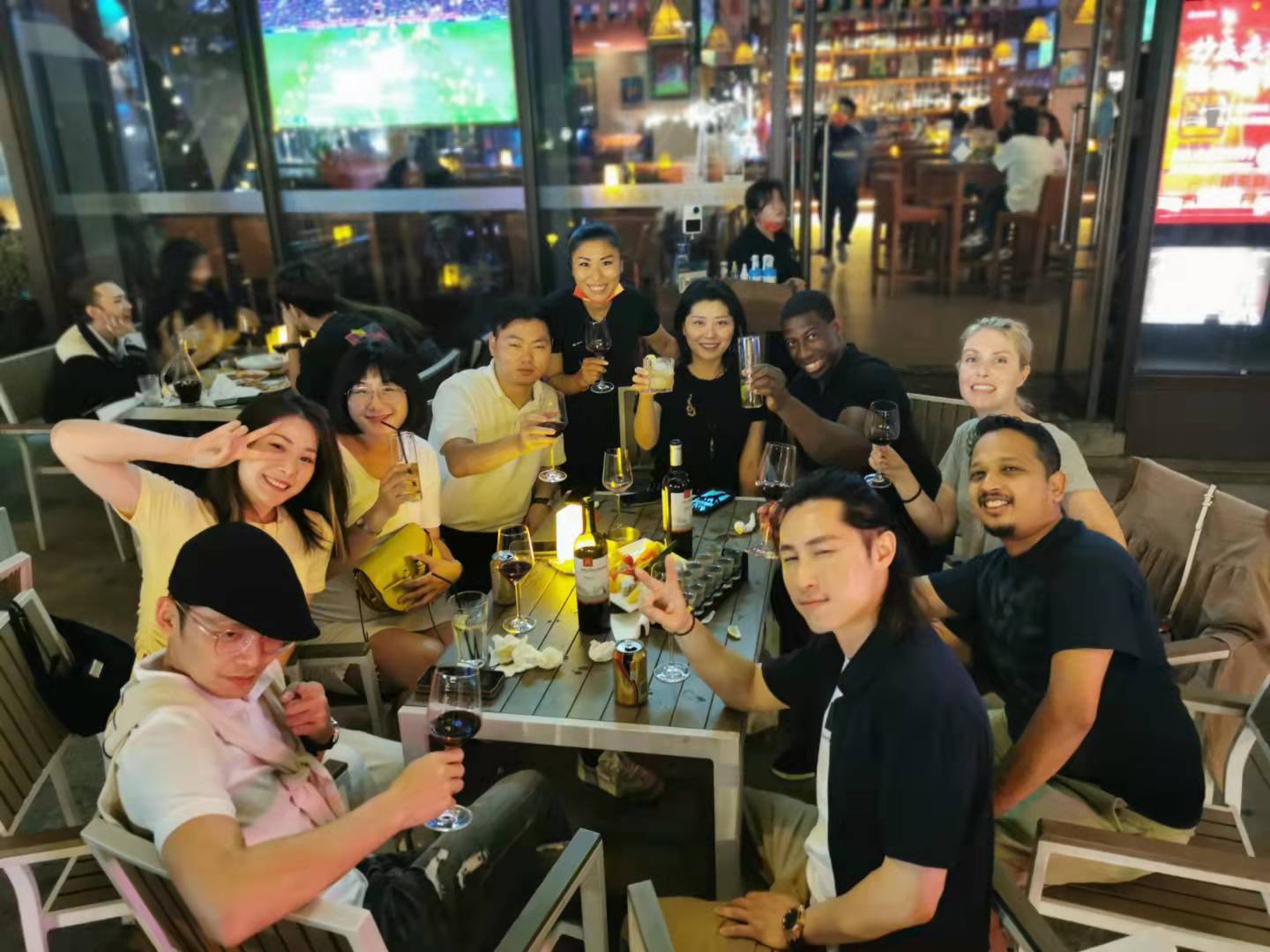 Friends gathered around an outdoor table in China