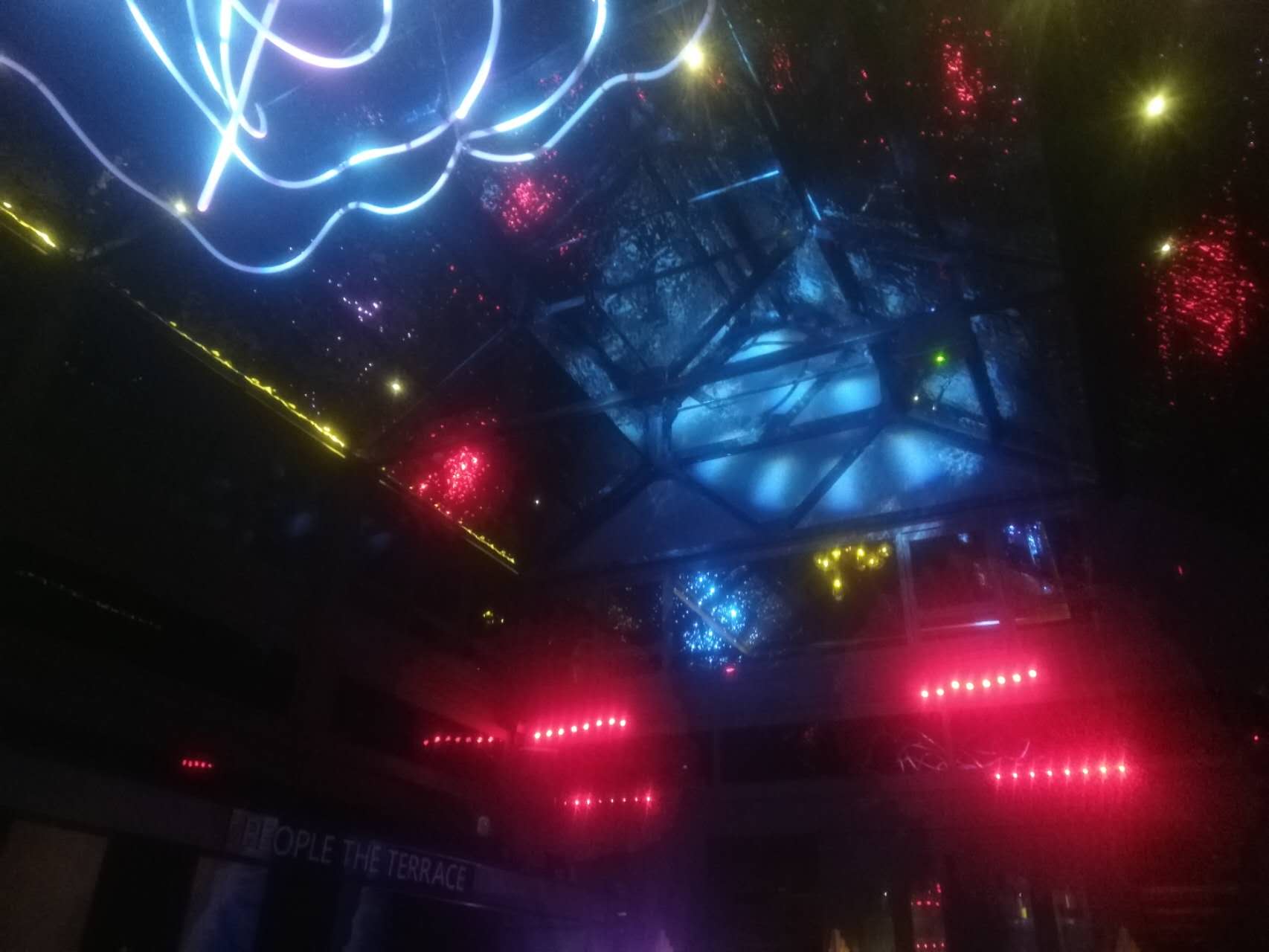 Blue and red lights illuminating an evening venue